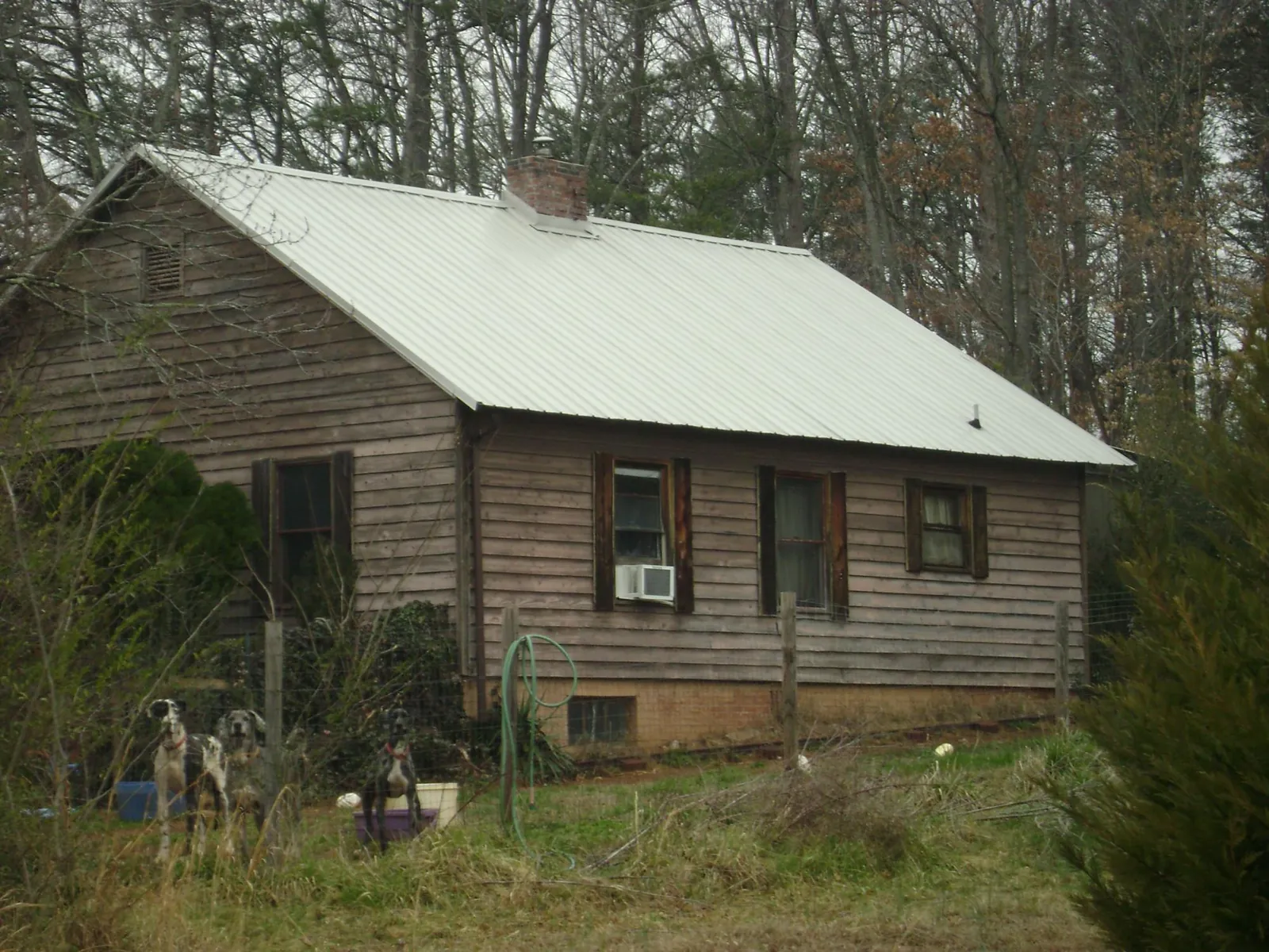 White metal roof on an old wood sided farmhouse, from a Metal Roof Installation job in Wexford